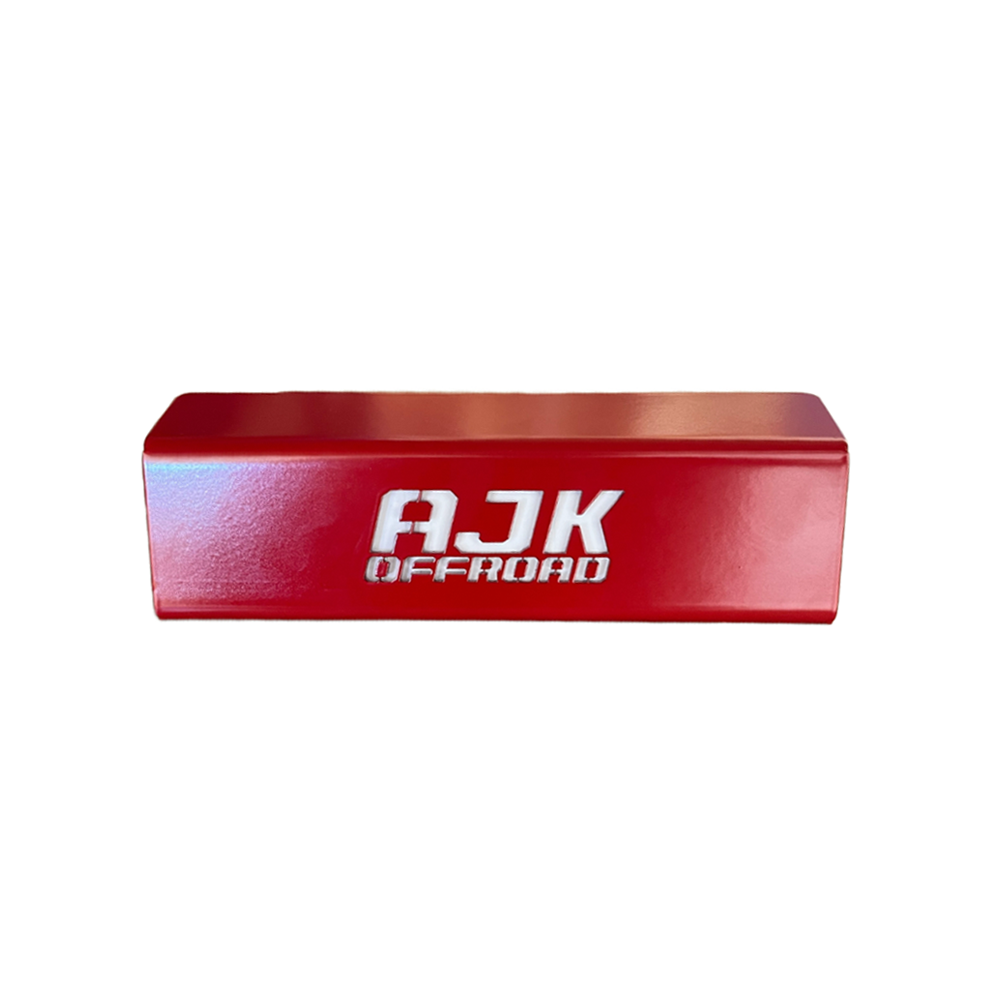 A red rectangular throttle control bracket with AJK Offroad in bold white letters, similar to a Honda Talon Foot Rest. It has a glossy finish and is against a plain white background, showcasing the precision typical of CNC laser-cut components.