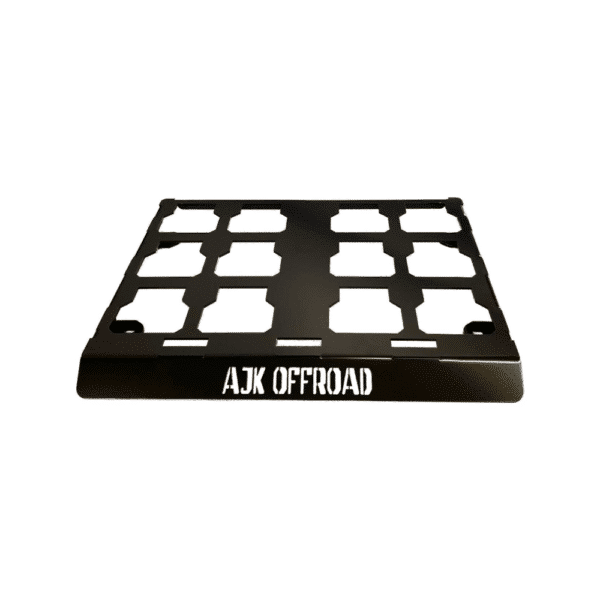 The Universal Milwaukee Packout Mount 1.0 by AJK Offroad is a black off-road accessory with a grid design, crafted using CNC laser cutting. It has AJK OFFROAD on a raised front panel and fits seamlessly with Milwaukee Packout Mount systems.